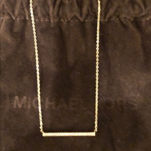 Michael Kors gold with cz bar necklace.